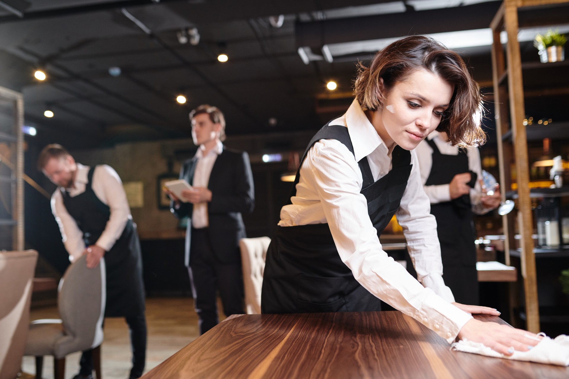 Busy waitress preparing restaurant for open and making cleanup